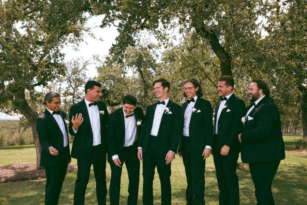groomsmen hanging out together at a hill country wedding